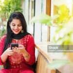 lady with phone in hand and smiling