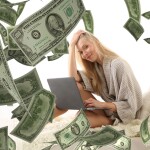 lady sitting with laptop and dollars